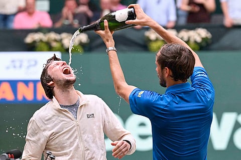 ALEXANDER Bublik (left) celebrates after beating Daniil Medvedev to win the Halle Open crown in Germany.   
