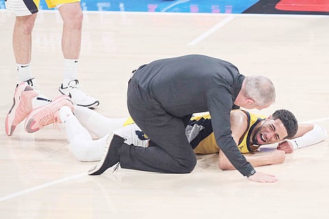 TYRESE Haliburton of the Indiana Pacers winces in pain after suffering a torn Achilles during their 91-103 loss to the Oklahoma City Thunder in Game 7 of the NBA Finals.