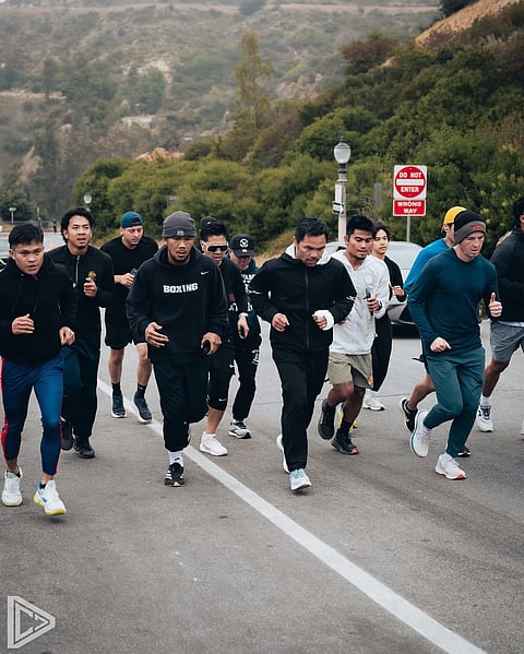 Manny Pacquiao (middle) is punishing himself in training for his comeback bid on 19 July in Las Vegas.