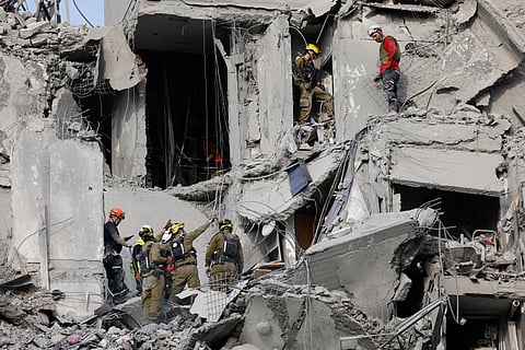 EMERGENCY workers check the damage caused to a building from an Iranian missile strike in Beersheba in southern Israel on June 24, 2025. Israeli emergency services said on June 24 three people were killed and two wounded in an Iranian missile strike in southern Israel, shortly before a staggered ceasefire announced by US President Donald Trump was meant to enter force.