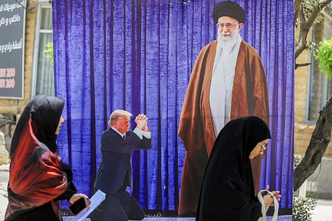 A poster depicting US President Donald Trump prostrating in font of Iran's Ayatollah Ali Kamenei hangs in a southern Beirut suburb, on 25 June 2025. President Donald Trump insisted on 25 June that US strikes led to the "total obliteration" of Iran's nuclear capabilities and set the country's atomic program back "decades", while Israel said it was still early to fully assess the damage.
