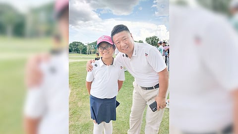 SUPERKIT top honcho Johnnie Wang is shown with junior golfer Penelope Sy.