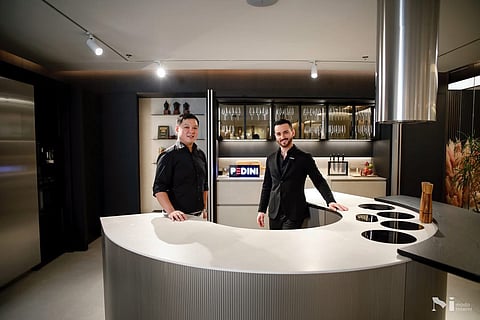 Goldwin Sison, President of Moda Interni, and Francesco Giuffrida with the Arké curved kitchen from Pedini