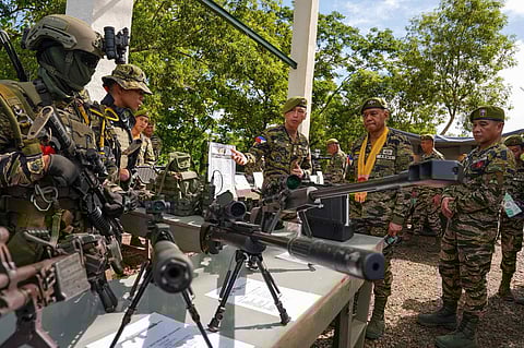Members of the Philippine Army’s Special Forces Regiment (Airborne) showcase their parachuting and combat skills and weaponry (inset) during the unit’s 63rd founding anniversary on Saturday.