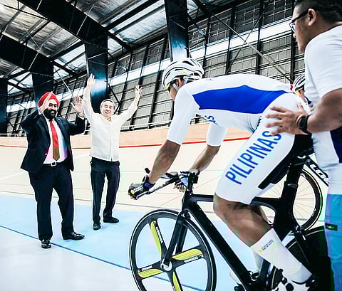 POC and cycling federation president Abraham 'Bambol' Tolentino (right) and ACC head Dato’ Amarjit Singh Gill flag off veteran Ronald Oranza during the inauguration recently of the Tagaytay City Velodrome.