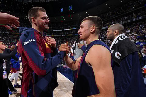 DENVER, CO - MAY 3: Nikola Jokic of the Denver Nuggets and Bogdan Bogdanovic of the LA Clippers after the game during Round 1 Game 7 of the 2025 NBA Playoffs on May 3, 2025 at Ball Arena in Denver, Colorado.