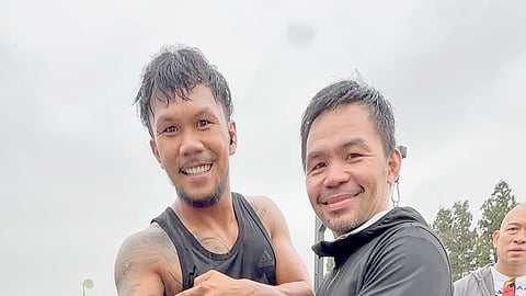 EUMIR Marcial beams with pride while showing the eight-division legend a Manny Pacquiao tattoo during a break in their training in Los Angeles.  