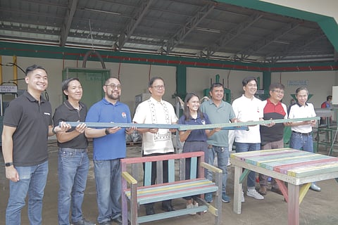 COMPOSITE bars made from plastic waste is presented by (from left) Gian Vega, PepsiCo e-commerce lead for Philippines; Alex Celis, PepsiCo supply chain manager for Philippines; Christopher Ilagan, PepsiCo corporate affairs head for Philippines, Malaysia, Singapore and North Asia; Congressman Atty. Arman Dimaguila Jr., former Biñan City mayor; Erica Cardoso, managing director of Evergreen Labs Philippines; Ronaldo Bayla, captain of Barangay Timbao; Councilor Jedi Alatiit, former chair on environment of the City of Biñan; Councilor Echit Desuasido, chair on environment of the City of Biñan; and Rodelio Lee, Biñan City Environment and Natural Resources Office Department head, during the inauguration of the Enhanced MRF at the Biñan Ecopark on 26 June 2025. The bar can be used as building material for making a bench and table (foreground). 