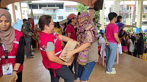 DSWD workers distribute 571 relief packs to families in Zamboanga City affected by Habagat flash floods.