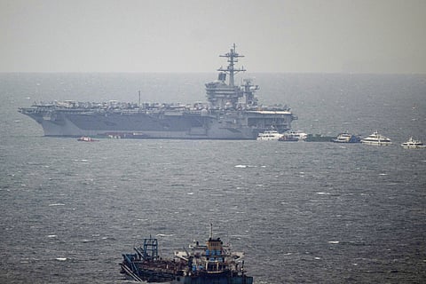 Steel diplomacy The USS George Washington (CVN-73) looms into view in the shimmering waters of Manila Bay, docking for a brief weekend visit.