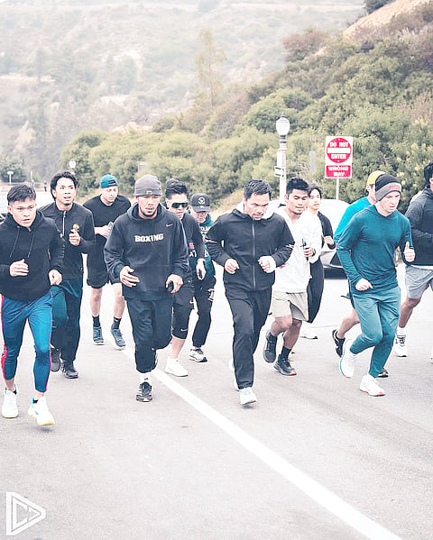 Manny Pacquiao (second from right) is on point for WBC welterweight champion Mario Barrios on 19 July as guaranteed by one of his top aides David Sisson (right), who joins the Filipino icon during his ascent of Griffith Park in Los Angeles.