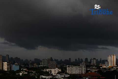 Dark rainclouds shroud a skyline as seen from Quezon City on the morning of 08 July 2025. The state weather bureau, PAGASA, has issued a localized thunderstorm warning that will bring moderate scattered rains to Metro Manila and nearby provinces.