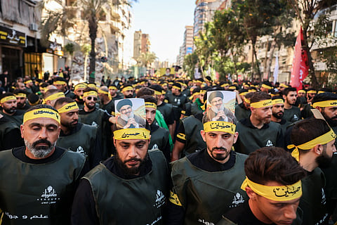 Lebanese Shiite Hezbollah supporters, with portraits of the movement's slain leader Hasan Nasrallah, take part in a ceremony during the peak of Ashura, a 10-day period commemorating the seventh century killing of Prophet Mohammed's grandson Imam Hussein, in Beirut's southern suburbs on July 6, 2025.
