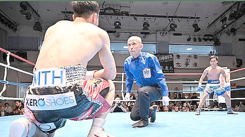 KENNETH Llover watches as Japanese foe Keita Kurihara receives a count in their OPBF bantamweight title fight last March in Tokyo.