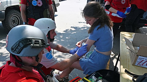 Medics provide assistance to a wounded woman following a drone attack in Kharkiv on July 7, 2025, amid the Russian invasion of Ukraine.
