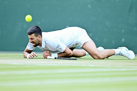 NOVAK Djokovic falls during his 6-7 (6/8), 6-2, 7-5, 6-4 victory over Flavio Cobolli in the men’s singles quarterfinals of the Wimbledon Championships.