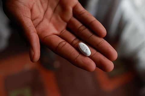 [FILE PHOTO] A patient shows a Vulante tablet, a medication and specifically a combination of tenofovir disoproxil fumarate and lamivudine, used for the treatment of HIV infection in adults aged 18 years and older at his home in Msogwaba township near Mbombela on March 12, 2025. The halt to US foreign aid risks "reversing" gains hard won over decades of global efforts to contain the AIDS pandemic, the United Nations said Thursday. Around 31.6 million people were on antiretroviral drugs in 2024 and deaths from AIDS-related illnesses had more than halved since 2010, the UN's UNAIDS agency said in a new report, but infections were likely to rise as funding cuts have shuttered prevention and treatment programmes.
