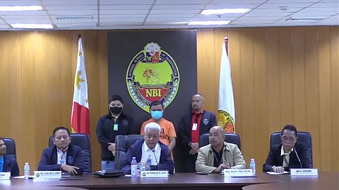 NBI presents suspect in fake CAAP license scheme during a press briefing.