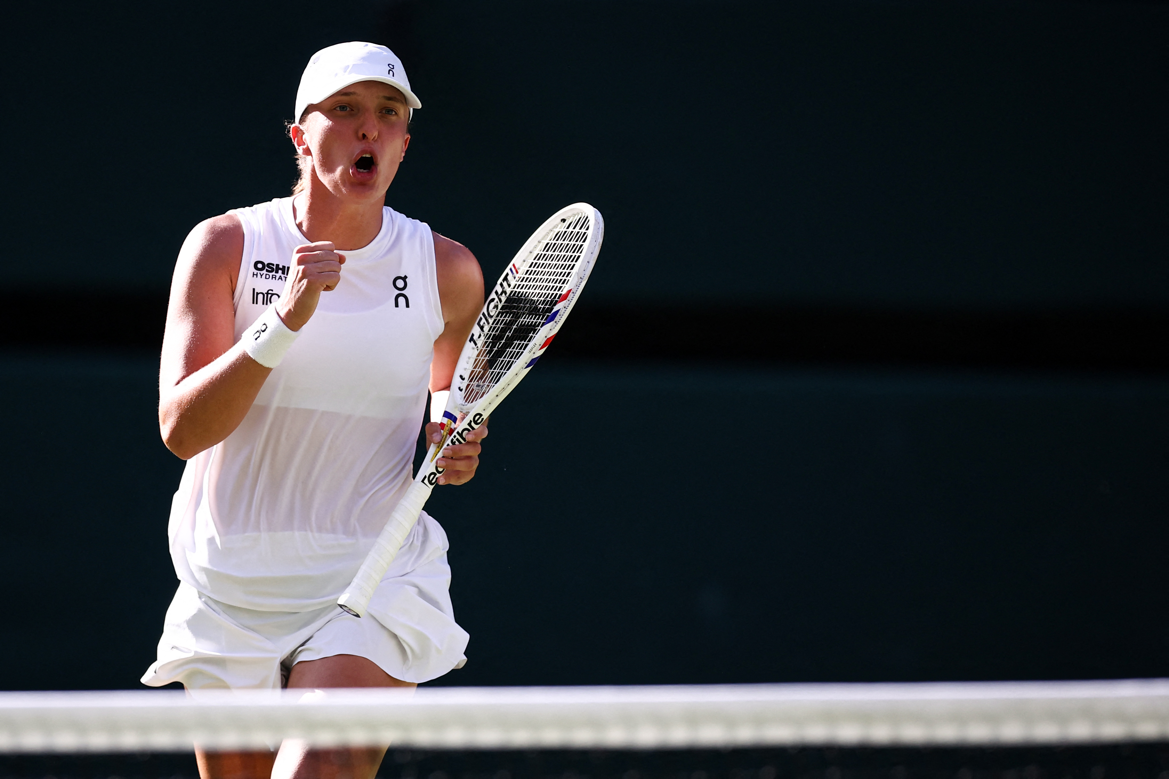 IGA Swiatek celebrates after pulling off a 6-2, 6-0 win over Belinda Bencic in the women’s event semifinals of the Wimbledon Championships.