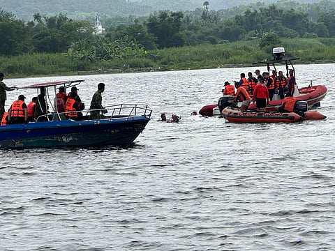 TECHNICAL divers of the PCG inspect the waters off Brgy. Balakilong, Laurel, Batangas, on Friday, where they found two sacks containing suspicious objects.