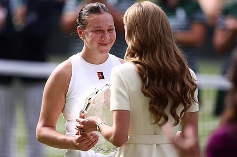 Britain's Catherine, Princess of Wales gives the runner up trophy, to US player Amanda Anisimova after her defeat against Poland's Iga Swiatek at the end of their women's singles final tennis match on the thirteenth day of the 2025 Wimbledon Championships at The All England Lawn Tennis and Croquet Club in Wimbledon, southwest London, on 12 July  2025.
