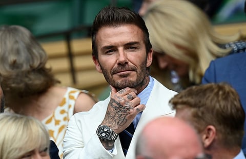 FORMER English footballer David Beckham (C) reacts as he sits in the Royal Box on Centre Court to watch the men's semi-finals on the eleventh day of the 2021 Wimbledon Championships at The All England Tennis Club in Wimbledon, southwest London, on July 9, 2021.
