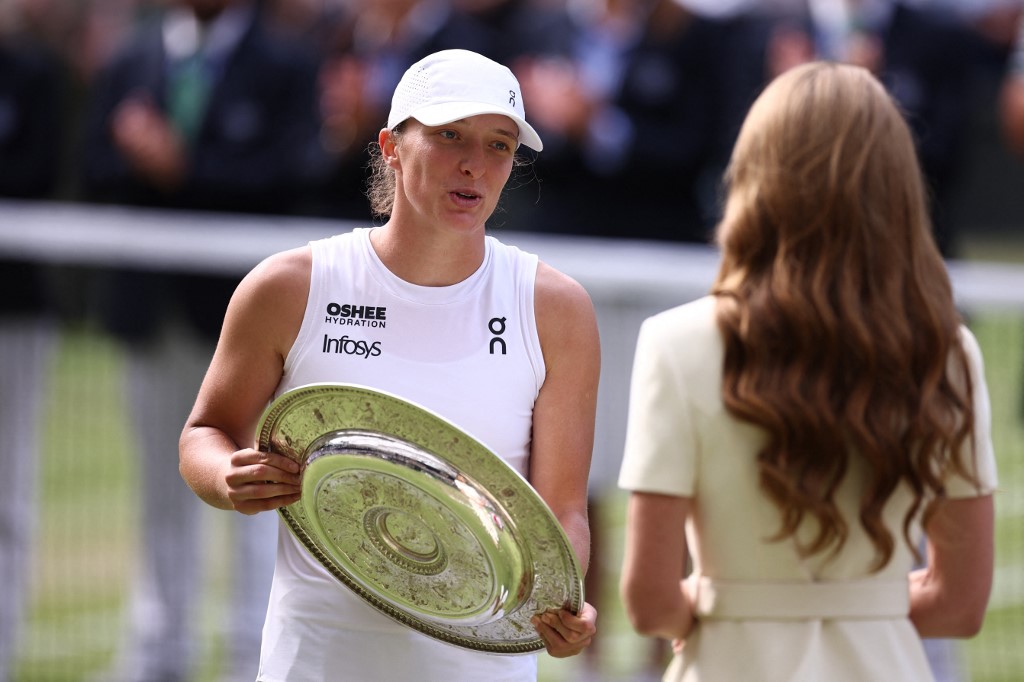 Britain's Catherine, Princess of Wales gives the winner's trophy, the Venus Rosewater Dish, to Poland's Iga Swiatek (L) after her victory against US player Amanda Anisimova at the end of their women's singles final tennis match on the thirteenth day of the 2025 Wimbledon Championships at The All England Lawn Tennis and Croquet Club in Wimbledon, southwest London, on 12 July 2025.
