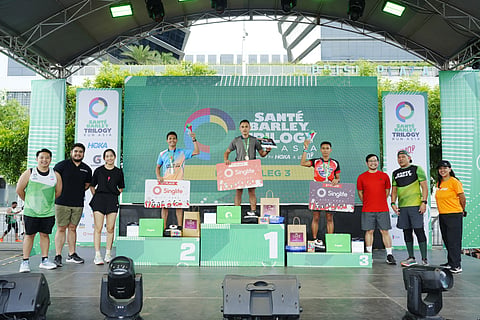ARLAN Arbios (center) rules the 32K male category of Leg 3 of the Sante Barley Trilogy Run Asia on Sunday at SM Mall of Asia Complex. Arbios shares the podium with Edsel Moral (left) and Mark Anthony Oximar.