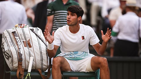 Spain's Carlos Alcaraz reacts after losing a game against Italy's Jannik Sinner during their men's singles final tennis match on the fourteenth day of the 2025 Wimbledon Championships at The All England Lawn Tennis and Croquet Club in Wimbledon, southwest London, on July 13, 2025.

