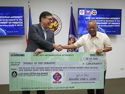 FINANCE Secretary Ralph Recto receives P1.4-billion worth of revenue earnings from SBMA Chairman and Administrator Eduardo Jose L. Aliño during a simple turnover ceremony held at the DOF Bldg., Bangko Sentral ng Pilipinas (BSP) Complex in Manila on 14 July 2025.
