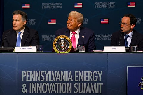 U.S. President Donald Trump (C) looks on during the inaugural Pennsylvania Energy and Innovation Summit at Carnegie Mellon University on July 15, 2025 in Pittsburgh, Pennsylvania.