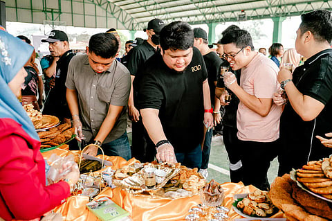 SECOND District Representative Omar Duterte (center) takes time to talk and taste the traditional Bangsamoro delicacies which highlighted the 122nd Araw ng Tigatto festivities. 
