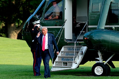 U.S. President Donald Trump lifts his hand in a salute as he exits Marine One on the South Lawn of the White House on July 15, 2025 in Washington, DC. Trump spent the afternoon visiting Pittsburgh, where he attended the inaugural Pennsylvania Energy and Innovation Summit at Carnegie Mellon University.