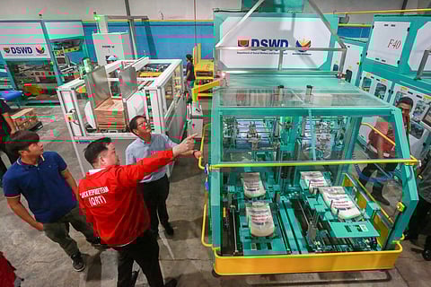 TO ensure efficient handling of relief goods as part of disaster preparedness, President Ferdinand R. Marcos Jr. inspects their preparation using the newly automated repacking machines at the warehouse of the Department of Social Welfare and Development-National Resource Operation Center in Pasay City on Friday, 18 July. Joining the President are presidential son Vincent Marcos, Social Welfare and Development Secretary Rex Gatchalian and other government officials. 