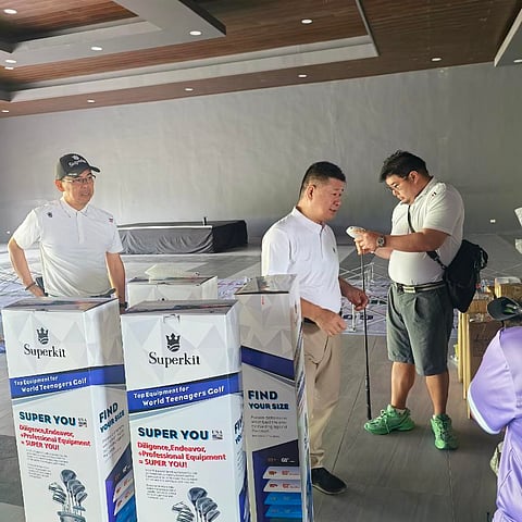 JGFP president Oliver Gan (right) and Superkit executives Johnny Wang (middle) and Stanley Loo inspect the equipment to be awarded to winners of the kickoff leg of the Superkit Junior Elite Golf Tour at the Vineyard Golf Club in Tanauan, Batangas on Friday.