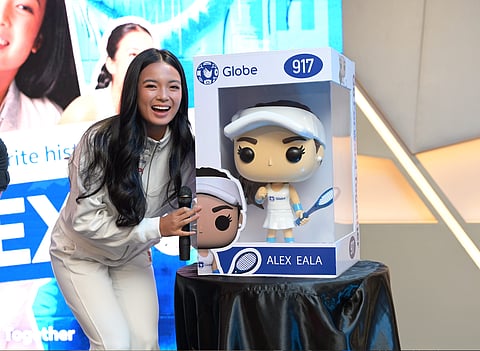 ALEX Eala smiles after Globe gifted her with a Funko Pop figure during an exclusive meet-and greet event on Friday.