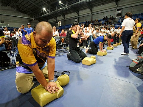 SBMA Chairman and Administrator Eduardo Jose L. Aliño talks to a Unilab official during the health caravan for Freeport stakeholders at the Subic Bay Gymnasium on 17 July 2025.