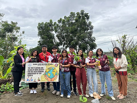 Jomari Tadeo (fourth from left) volunteers at a tree planting activity arranged by his school. 