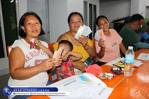 FISHERFOLK show off the assistance they received during the one-day Capability Training on the Development of the Salt Industry Project (DSIP) in Brgy. Dikapanikian, Dingalan, Aurora. 