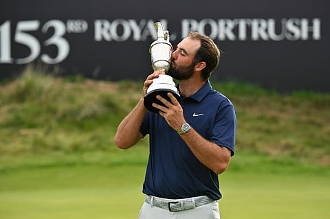 US golfer Scottie Scheffler kisses the Claret Jug, the trophy for the Champion golfer of the year after his victory in the 153rd Open Championship at Royal Portrush golf club in Northern Ireland on July 20, 2025. Scottie Scheffler romped to a magnificent four-shot victory to seal his first British Open title at Royal Portrush on Sunday, notching his fourth major success. The world number one eased to a three-under par final round of 68, finishing on 17-under for the tournament after shooting in the 60s on all four days.

