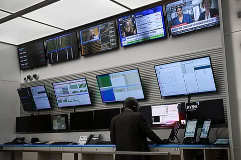 Multiple screens monitoring the New York Stock Exchange reflect upbeat company earnings and healthy US data, pushing ongoing concerns about President Donald Trump’s tariffs into the background. Most European and Asian markets were pulled higher as well.