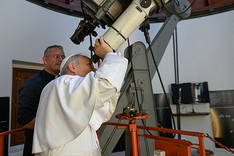 THIS handout photo taken and released on July 20, 2025 by the Vatican press office, Vatican Media shows Pope Leo XIV looking through a telescope during his visit at the Vatican Observatory, Specola in the summer papal estate in Castel Gandolfo, 40 km southeast of Rome. The newly elected Pope Leo XIV, revives a long-standing papal tradition paused under Francis, as Castel Gandolfo prepares to welcome a pope for the first time in over a decade.