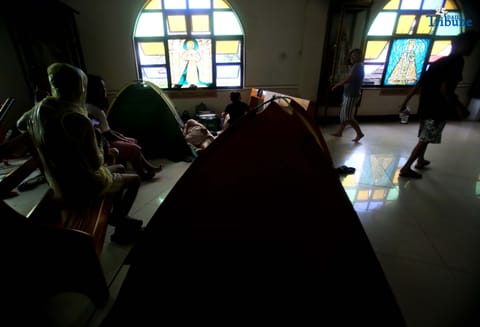 Evacuees take temporary shelter at Santa Lucia Parish in Barangay Sta. Lucia, Novaliches, Quezon City on Tuesday, July 22, 2025, after rising waters from Tullahan River submerged homes amid nonstop rains brought by the southwest monsoon. 