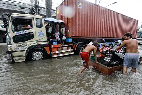 Residents and commuters in Dalandanan, Valenzuela City wades through knee deep flood as continues overnight rain hit Metro Manila.