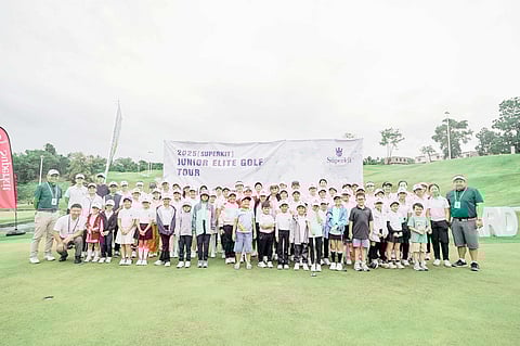 PARTICIPANTS in the kickoff leg of the Superkit Junior Elite Golf Tour brave the rains at the Vineyard Golf Club in Tanauan, Batangas on Saturday.