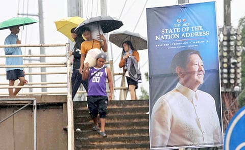 Banners rise before the speech. A tarpaulin heralding President Ferdinand Marcos Jr.’s fourth State of the Nation Address stands along Commonwealth Avenue. The SoNa is set on the 28th.