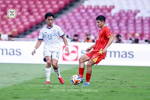 Zachary Taningco (left) of the Philippines makes his move against a Vietnamese defender in their Asean U23 Championships match on Friday in Jakarta. Vietnam won, 2-1.