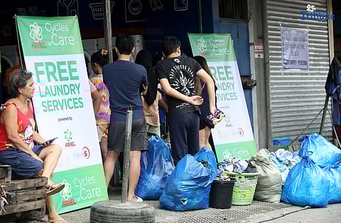 Residents near Nega-Qmart in Cubao, Quezon City, line up to avail of free laundry services at Save5 laundry center, part of Ariel Philippines' “Cycles of Care” initiative. The three-week relief program offers complimentary laundry services to families affected by recent typhoons and habagat rains across 30 branches in Metro Manila, in partnership with Save5.