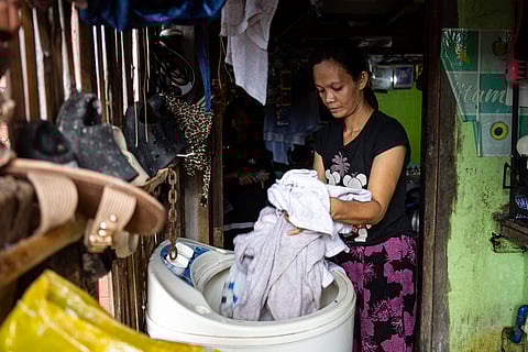 Sharon Atay, a mother of five, is among the many residents of the Baseco community who seize the opportunity to do laundry while the sun is still out, following weeks of incessant rain brought by the southwest monsoon, or habagat, and other typhoons, in Manila on Saturday, 26 July 2025.
