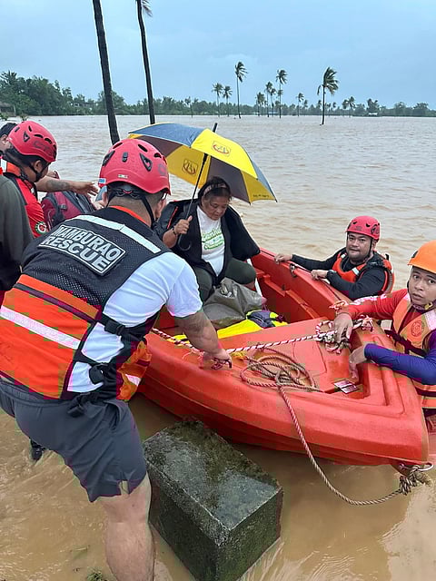 RESCUERS wade through chest-deep floodwaters to reach stranded residents in Mamburao, Occidental Mindoro, following hours of relentless rain. With homes submerged and roads impassable, emergency teams worked tirelessly to bring families to safety.